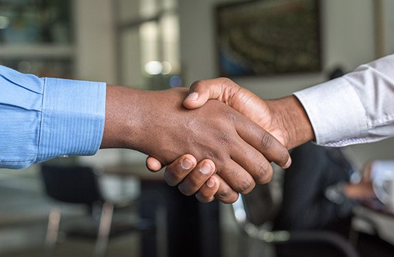 Employee and employer shaking hands