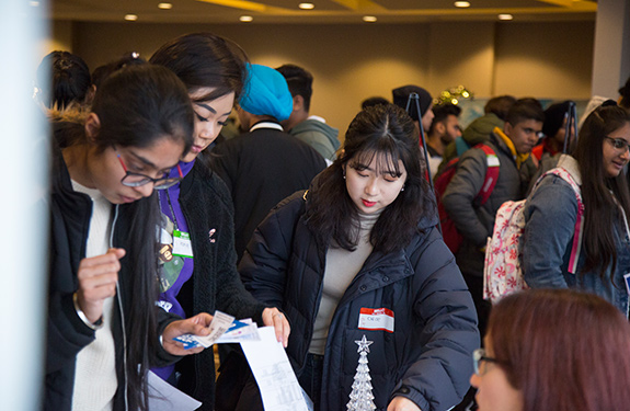 Students checking program during orientation