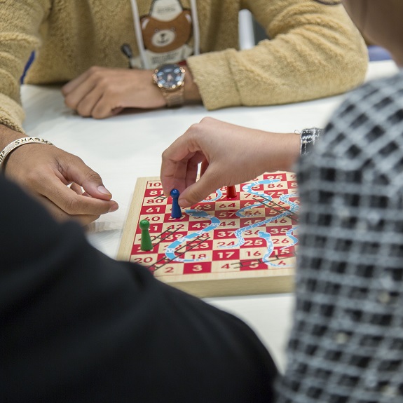Close up image of students playing a board game