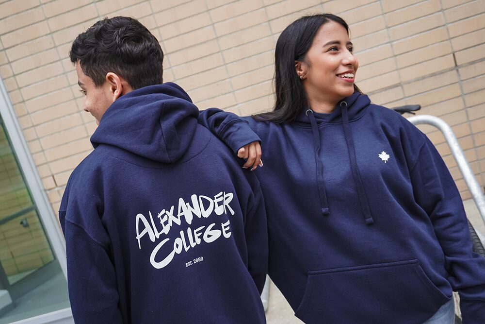 Students showing off navy hoodies